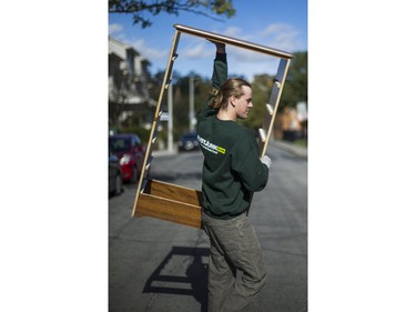 Liam Hamilton, of JUSTJUNK, helps to clear out various thing no longer needed from a home in Toronto, Ont. on Wednesday October 25, 2017.