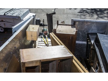 Jeremy Borda, of JUSTJUNK, clears out various thing no longer needed from a home in Toronto, Ont. on Wednesday October 25, 2017.