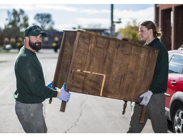 Jeremy Borda (left) and Liam Hamilton, of JUSTJUNK, clear out a home of things no longer needed in Toronto, Ont. on Wednesday October 25, 2017.