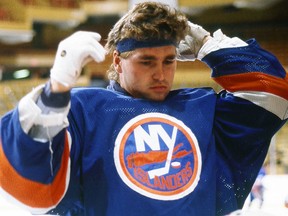 In this 1980 file photo, Kelly Hrudey of the New York Islanders adjusts his headband. (Steve Babineau/NHLI via Getty Images)