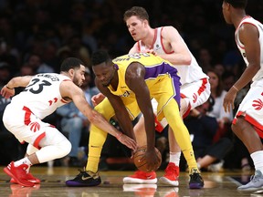 Kyle Lowry, Jakob Poeltl and Fred VanVleet of the Toronto Raptors defend against Julius Randle of the Los Angeles Lakers (Getty)