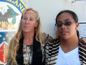 In this Wednesday, Oct. 25, 2017 frame from video provided by the U.S. Navy, Jennifer Appel, left, and Tasha Fuiava, who with their dogs were rescued after being lost at sea for several months while trying to sail from Hawaii to Tahiti, are interviewed aboard the USS Ashland in the South Pacific Ocean.
