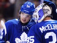 Maple Leafs centre Auston Matthews celebrates with goalie Curtis McElhinney after defeating the Red Wings on Oct. 18, 2017. (THE CANADIAN PRESS/Nathan Denette)