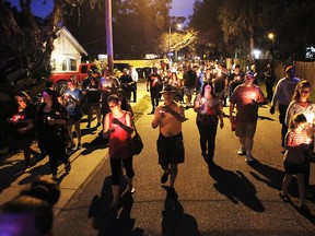 A peaceful march that began on east New Orleans Avenue was held during a candlelight vigil for the three victims who were killed in the recent shootings in the Seminole Heights neighborhood in Tampa on Sunday, Oct. 22, 2017. The deaths, which took place in the same neighborhood over the past 10 days, prompted Tampa police to warn residents in the Seminole Heights neighborhood not to walk alone at night.(Octavio Jones/The Tampa Bay Times via AP)