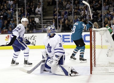 Toronto Maple Leafs goalie Frederik Andersen, center, is beaten for a goal by San Jose Sharks' Joe Pavelski, right, during the second period of an NHL hockey game Monday, Oct. 30, 2017, in San Jose, Calif. (AP Photo/Marcio Jose Sanchez) ORG XMIT: SJA111