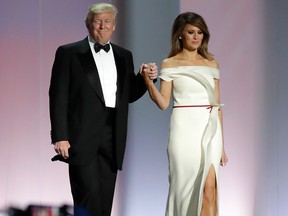 In this Jan. 20, 2017, file photo President Donald Trump arrives with first lady Melania Trump at the Liberty Ball in Washington. Melania Trump is donating her inaugural ball gown to the first ladies’ collection at the Smithsonian Institution. The first lady is handing over the vanilla silk, off-the-shoulder gown during a ceremony on Oct. 20. (AP Photo/Patrick Semansky, File)