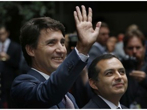 Prime Minister Justin Trudeau, accompanied by Mexican Senate President Ernesto Cordero, right, waves upon his arrival to the Mexican Senate, in Mexico City, Friday, Oct. 13, 2017.  (AP Photo/Marco Ugarte)