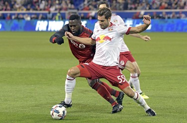 New York Red Bulls defender Damien Perrinelle (55) holds off Toronto FC forward Jozy Altidore (17) during the first half of an MLS Eastern Conference semifinal soccer match, Monday, Oct. 30, 2017, in Harrison, N.J.. (AP Photo/Bill Kostroun) ORG XMIT: NJBK103