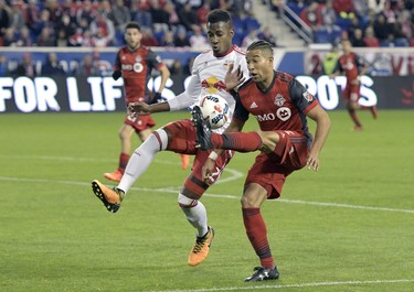 Toronto FC defender Justin Morrow, right, controls the ball as New York Red Bulls defender Michael Murillo defends during the second half of an MLS Eastern Conference semifinal soccer match Monday, Oct. 30, 2017, in Harrison, N.J. Toronto FC won 2-1. (AP Photo/Bill Kostroun) ORG XMIT: NJBK106