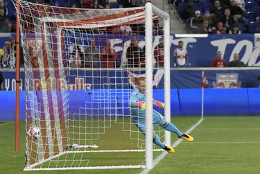 New York Red Bulls goalkeeper Luis Robles (31) cannot stop a goal by Toronto FC forward Sebastian Giovinco (not shown) during the second half of an MLS Eastern Conference semifinal soccer match Monday, Oct. 30, 2017, in Harrison, N.J. Toronto FC won 2-1. (AP Photo/Bill Kostroun) ORG XMIT: NJBK110
