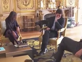 Nemo, the dog of French President Emmanuel Macron, interupts a meeting by urinating against a fireplace. (YouTube)