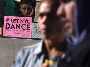 A sign to repeal NYC's Cabaret Law is seen posted at the Brooklyn venue Secret Project Robot on October 20, 2017 in New York.