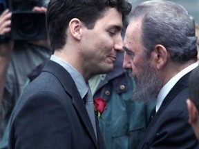 Trudeau gets a hug from late Cuban President Fidel Castro at the arrival in front of Notre Dame Church prior to the funeral of his father Pierre Trudeau on Oct. 3, 2000