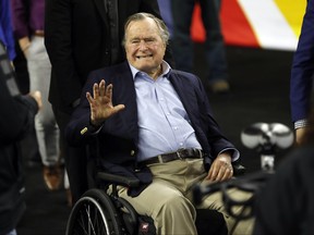 In this April 2, 2016, file photo, former President George H. W. Bush waves as he arrives at NRG Stadium before the NCAA Final Four tournament college basketball semifinal game between Villanova and Oklahoma in Houston. (AP Photo/David J. Phillip, File)