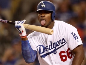 Yasiel Puig of the Los Angeles Dodgers licks his bat during Game 2 (Christian Petersen/Getty Images)