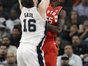 San Antonio Spurs forward Pau Gasol (16) is blocked by Toronto Raptors guard Delon Wright (55) as he tires to score during the first half of an NBA basketball game, Monday, Oct. 23, 2017, in San Antonio. (AP Photo/Eric Gay)
