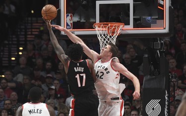 Portland Trail Blazers forward Ed Davis puts up a shot over Toronto Raptors center Jakob Poeltl during the first quarter of an NBA basketball game in Portland, Ore., Monday, Oct. 30, 2017. (AP Photo/Steve Dykes) ORG XMIT: ORSD105