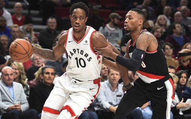 Toronto Raptors guard DeMar DeRozan drives to the basket on Portland Trail Blazers guard Damian Lillard during the first quarter of an NBA basketball game in Portland, Ore., Monday, Oct. 30, 2017. (AP Photo/Steve Dykes) ORG XMIT: ORSD107