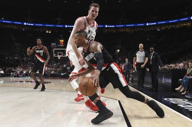 Portland Trail Blazers guard Damian Lillard drives to the basket on Toronto Raptors center Jakob Poeltl during the fourth quarter of an NBA basketball game in Portland, Ore., Monday, Oct. 30, 2017. The Raptors won 99-85. (AP Photo/Steve Dykes) ORG XMIT: ORSD110