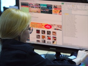 This picture taken on July 24, 2017 shows an employee of Santa Cruise "digital laundry" company monitoring a computer screen to find "revenge porn" at the company in Seoul.