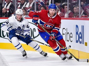 Karl Alzner of the Montreal Canadiens skates the puck against Morgan Rielly of the Toronto Maple Leafs during the NHL game at the Bell Centre on Oct.14, 2017 in Montreal. (Minas Panagiotakis/Getty Images)