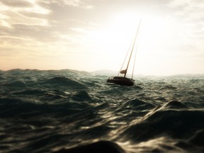 Lost sailing boat in wild stormy ocean. Cloudy sky.