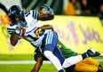 Toronto Argonauts' S. J. Green, front, makes a catch for a convert as Edmonton Eskimos' Brandyn Thompson tries to stop him during second half CFL football action in Edmonton, Saturday, Oct. 14, 2017. THE CANADIAN PRESS/Jeff McIntosh