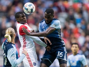 San Jose Earthquakes' Kofi Sarkodie, second left, and Vancouver Whitecaps' Tony Tchani vie for the ball as Brek Shea, front left, watches during the first half of an MLS soccer game in Vancouver, B.C., on Sunday October 15, 2017. THE CANADIAN PRESS/Darryl Dyck