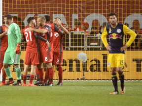 Toronto FC teammates celebrate following their 4-2 victory over the New York Red Bulls in MLS soccer action Saturday September 30, 2017 in Toronto. THE CANADIAN PRESS/Jon Blacker