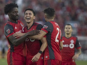 Toronto FC's Marco Delgado (centre) celebrates with Tosaint Ricketts (left) and Jonathan Osorio after scoring his team's fourth goal against the Portland Timbers during second half MLS action in Toronto on Saturday, August 12, 2017. THE CANADIAN PRESS/Chris Young