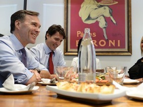 Finance Minister Bill Morneau and Prime Minister Justin Trudeau chat over lunch with the owners of family-run restaurant in Whitchurch-Stouffville, Ont., on Monday, October 16, 2017.