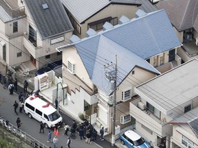 This aerial photo shows the apartment, center, where police found dismembered bodies in coolers in Zama city, southwest of Tokyo, Tuesday, Oct. 31, 2017.  A police spokesman said Tuesday the 27-year-old suspect confessed to cutting up the bodies and hiding them in cold-storage cases, covered with cat litter. (Kyodo News via AP)
