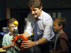 Prime Minister Justin Trudeau participates in a science experiment at the Telus World of Science in Edmonton on May 20, 2017 where he met with families to bring attention to the Canada Child Benefit. (Larry Wong/Postmedia/Files)