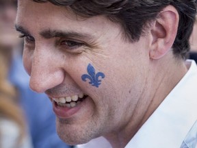 Prime Minister Justin Trudeau sports a Fleur de Lys on his check at a street party for the Fete National du Quebec, Saturday, June 24, 2017 in Montreal. THE CANADIAN PRESS/Paul Chiasson