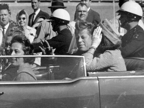 In this Nov. 22, 1963 file photo, President John F. Kennedy waves from his car in a motorcade in Dallas. Riding with Kennedy are First Lady Jacqueline Kennedy, right, Nellie Connally, second from left, and her husband, Texas Gov. John Connally, far left. President Donald Trump, on Saturday, Oct. 21, 2017, says he plans to release thousands of never-seen government documents related to President John F. Kennedy's assassination. (AP Photo/Jim Altgens, File)
