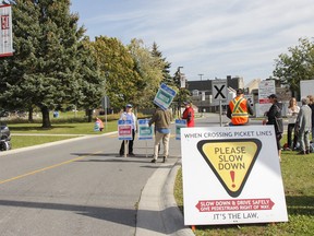 Local college faculty walk a picket line and speak with drivers entering all three entrances to St. Lawrence College Kingston campus on Thursday October 19, 2017 as the province-wide teachers strike enters its fourth day, with the no scheduled talks between Ontario Public Service Employees Union (OPSEU), representing faculty, and the College Employer Council.