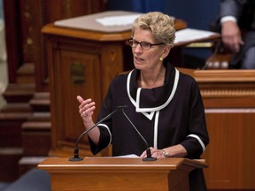 Ontario Premier Kathleen Wynne speaks at the National Assembly in Quebec City on September 21, 2017. Ontario's premier says she is taking another step toward a defamation lawsuit against the province's Opposition leader. Kathleen Wynne's lawyer demanded in a letter last month that Progressive Conservative Leader Patrick Brown retract comments suggesting the premier is personally on trial.