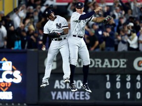 Aaron Hicks and Aaron Judge of the New York Yankees celebrate after defeating the Houston Astros in Game 5 of the American League Championship Series at Yankee Stadium on Oct. 18, 2017. (Al Bello/Getty Images)