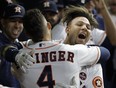 Astros' Yuli Gurriel (right) is congratulated by George Springer after hitting a home run during the second inning of Game 3 of the World Series against the Dodgers in Houston on Friday, Oct. 27, 2017. (David J. Phillip/AP Photo)