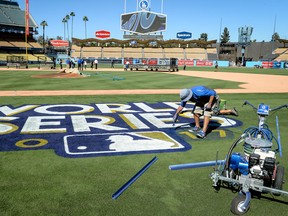 Finishing touches are put on to the World Series logo on Oct. 23, 2017, in Los Angeles. (David Crane/The Orange County Register via AP)