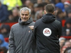 Manchester United manager Jose Mourinho  exchanges words with fourth official Stuart Attwell during a game against Tottenham. (AP)
