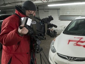 A cameraman shoots a swastika painted on one of several cars in Montreal in February, 2015.
Police called it a hate crime. . Vandals damaged five cars and left bullets and threatening notes.