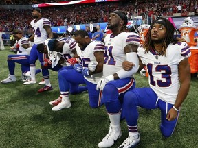 Buffalo Bills players take a knee during the national anthem on Sunday, Oct. 1, 2017, in Atlanta.