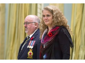 Governor General Julie Payette stands with the Dominion President of the Royal Canadian Legion Davi Flannigan after receiving the first poppy for the National Poppy campaign during a ceremony at Rideau Hall in Ottawa on October 23, 2017. (THE CANADIAN PRESS/Adrian Wyld)