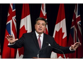 Ontario Finance Minister Charles Sousa speaks to reporters in Queens Park in Toronto on Tuesday, November 14, 2017.
