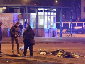 Italian police and forensics experts stand by the body of  Berlin truck attacker Anis Amri after he was shot dead in Milan on December 23, 2016.