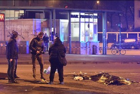 Italian police and forensics experts stand by the body of  Berlin truck attacker Anis Amri after he was shot dead in Milan on December 23, 2016.