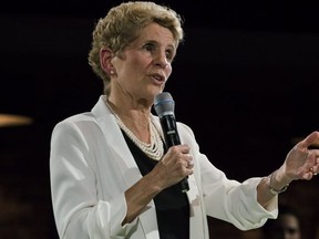Premier Kathleen Wynne addresses questions from the public during a town hall meeting in Toronto on Nov. 20.