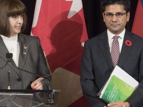 Ontario's Minister for Government Services Marie-France Lalonde (left) stands with the Province's Attorney General Yasir Naqvi