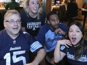 Toronto Argonauts fans cheer on their team at the Grey Cup on Sunday at Shoeless Joes on King St. From left to right,  Michael Gibson, Erin Wylie, Joe Anandjit and Bonnie Kim.